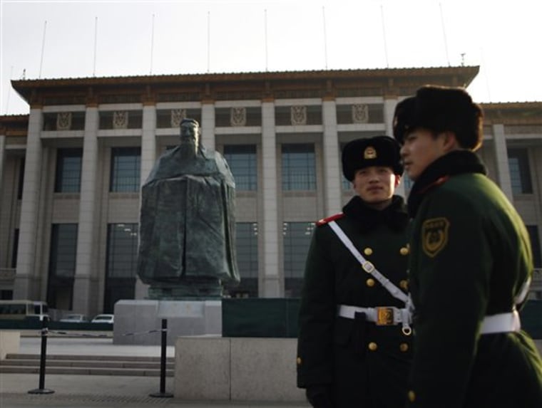 Chinese paramilitary policemen stands guard in front of a sculpture of the ancient philosopher Confucius on display near the Tiananmen Square in Beijing, China's capital. The mammoth sculpture of Confucius was unveiled this week on one side of the giant plaza, the political heart of China. It's a curious juxtaposition for a site that's heavy with Communist history — Mao's body is interred in the middle of it and his giant portrait hangs at one end.